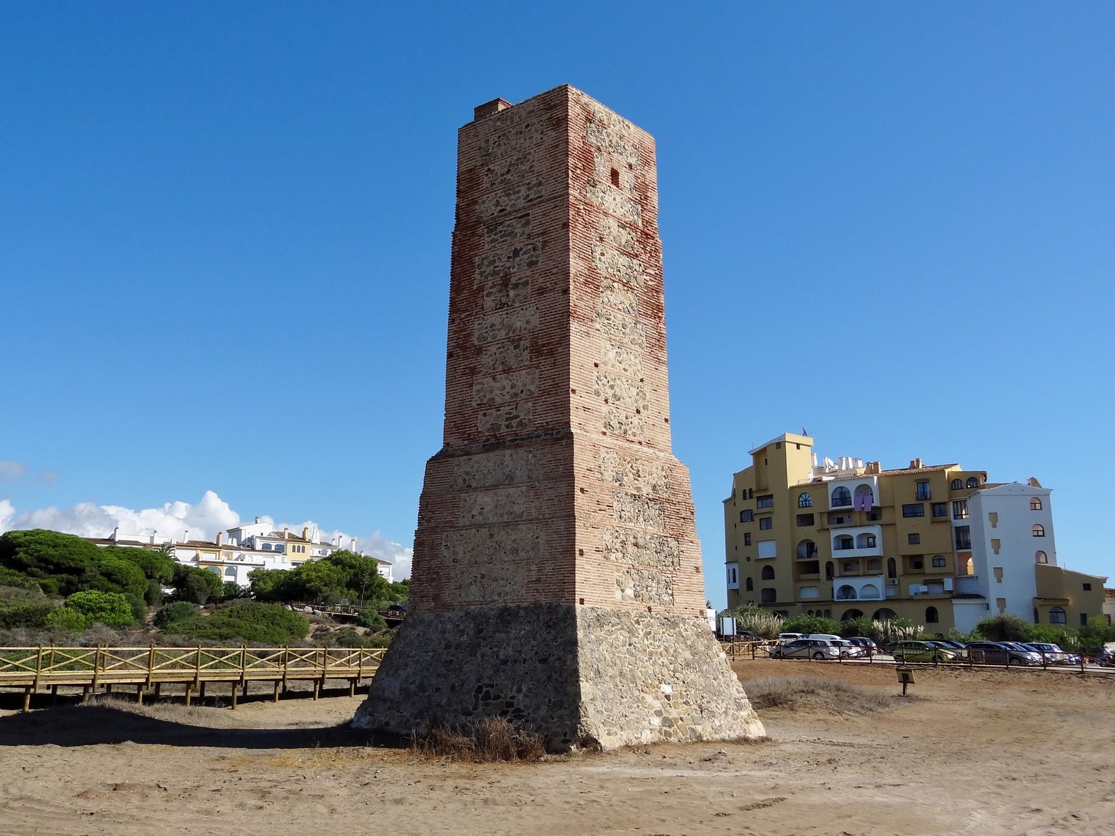 The Torre Ladrones on the dunes at Cabopino, Marbella, the village rising behind it. Photograph: Olaf Tausch, CC BY 3.0.