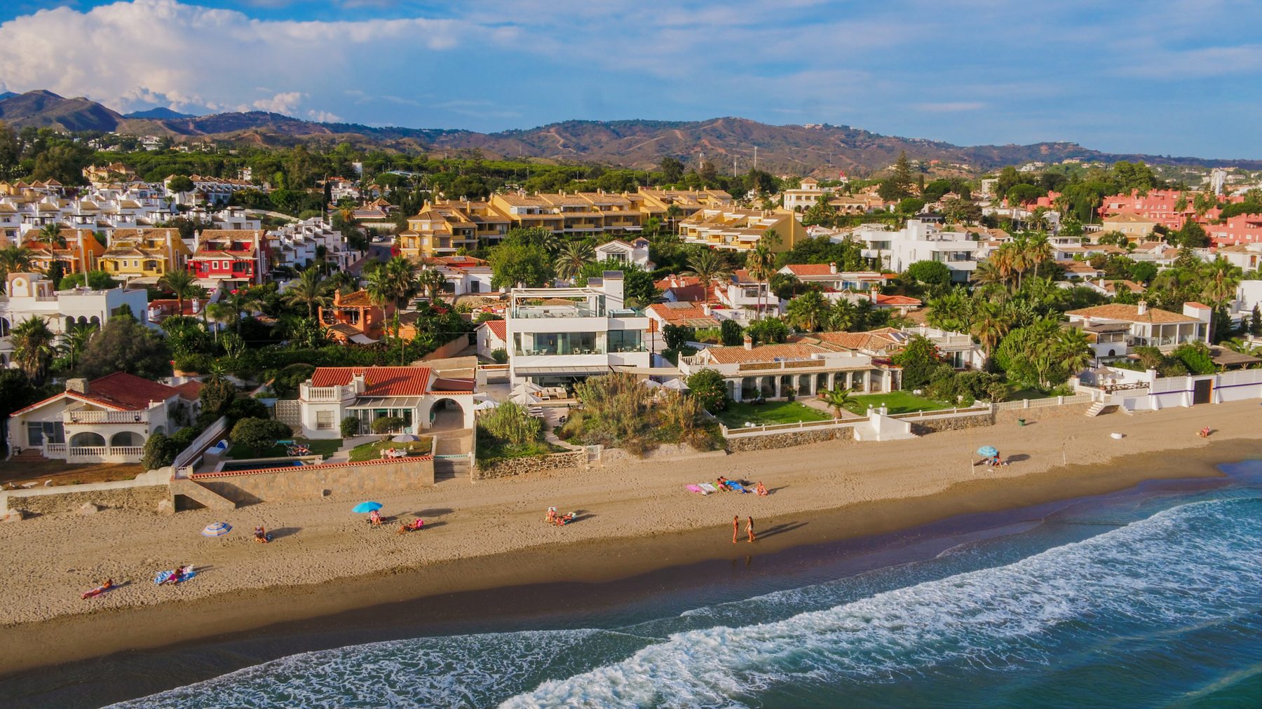 Costabella from the air, the low houses of the estate behind its beach, Marbella