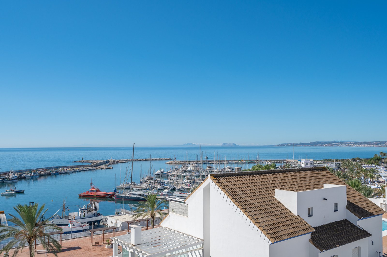 Estepona marina and the fishing harbour, seen over the rooftops of the old quarter