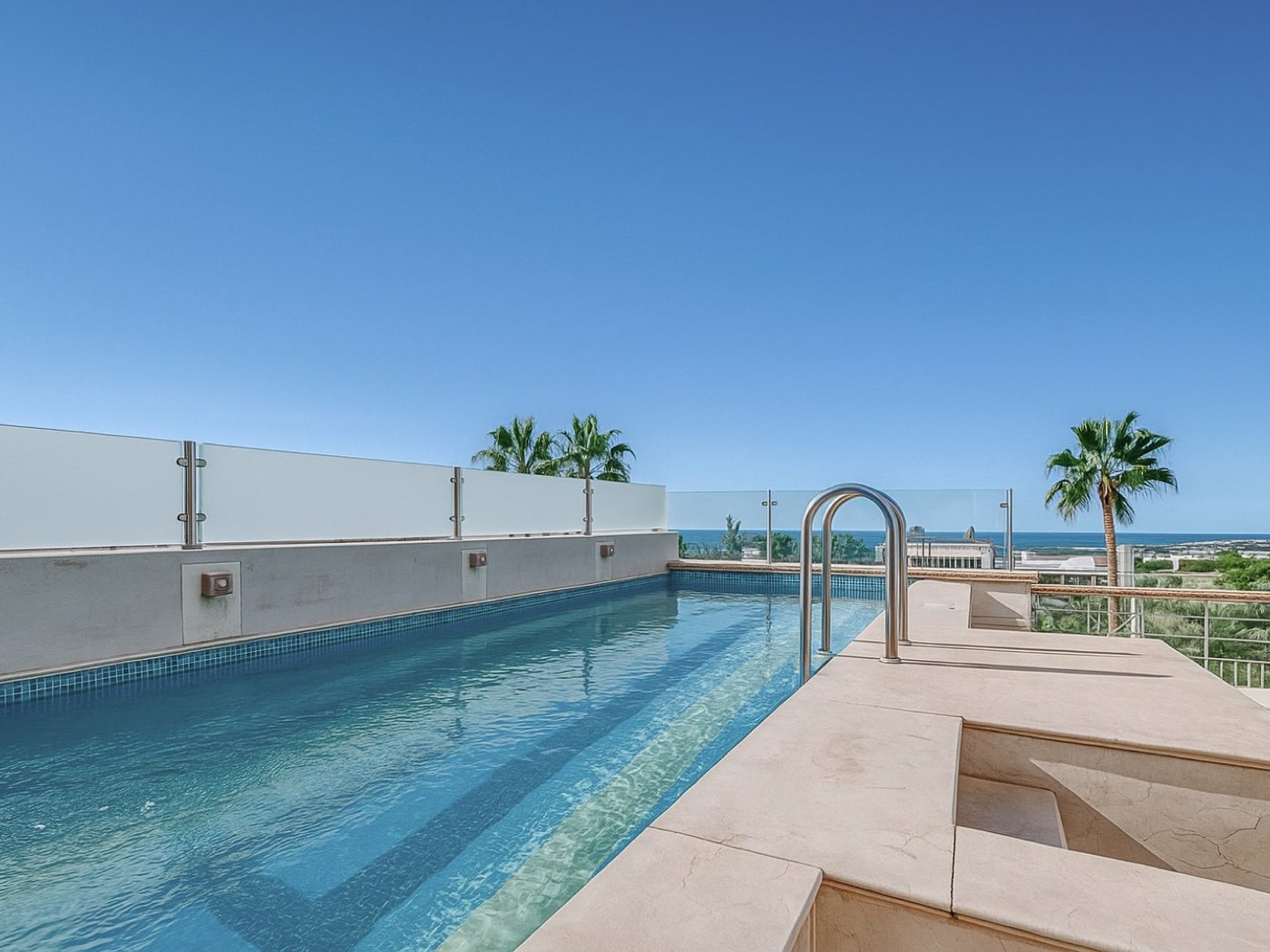 A pool terrace on the Golden Mile in the late afternoon