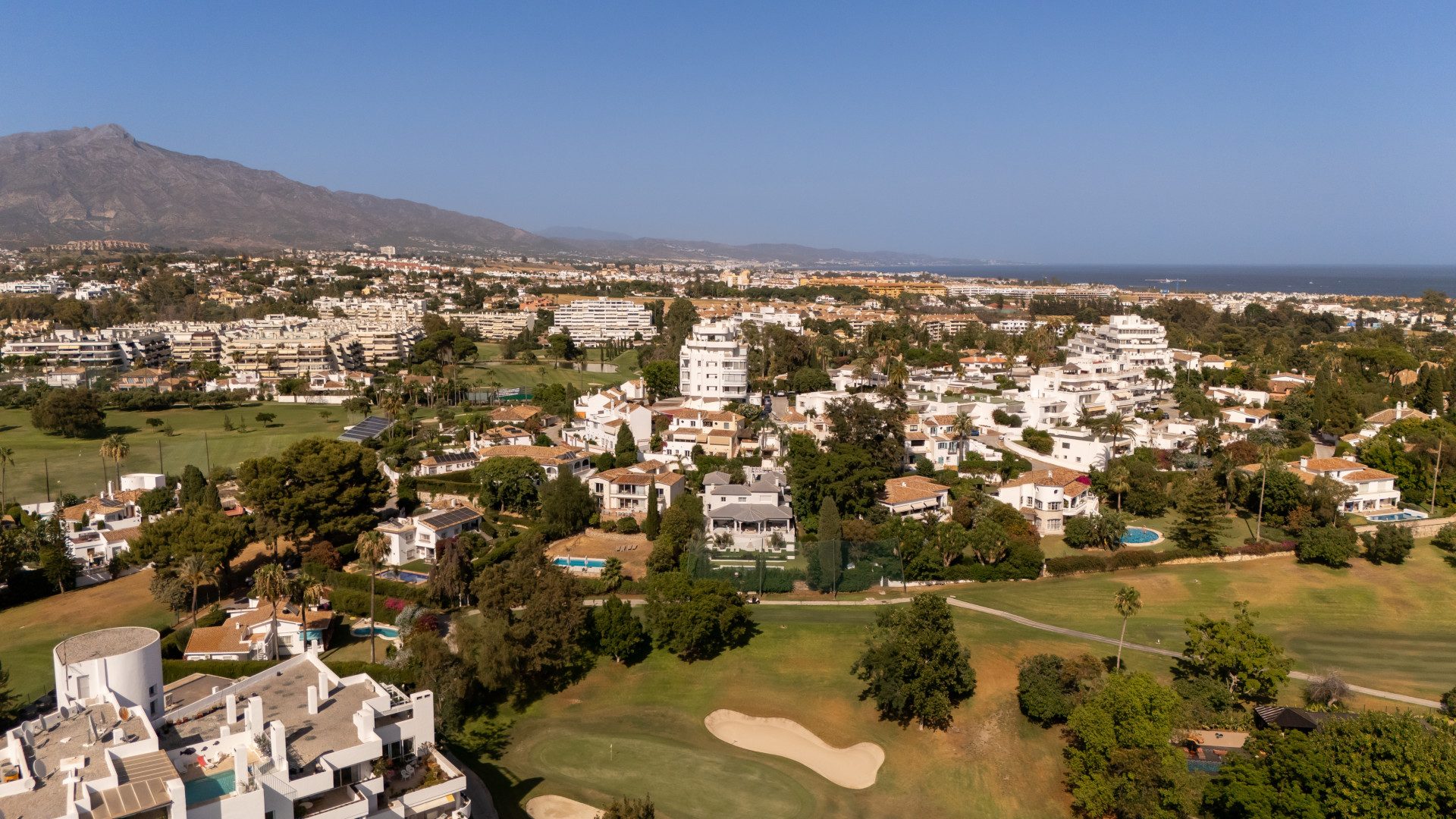 Guadalmina from the air: the golf course, the white villas and tiled roofs on their plots, La Concha to the north and the Mediterranean on the eastern horizon