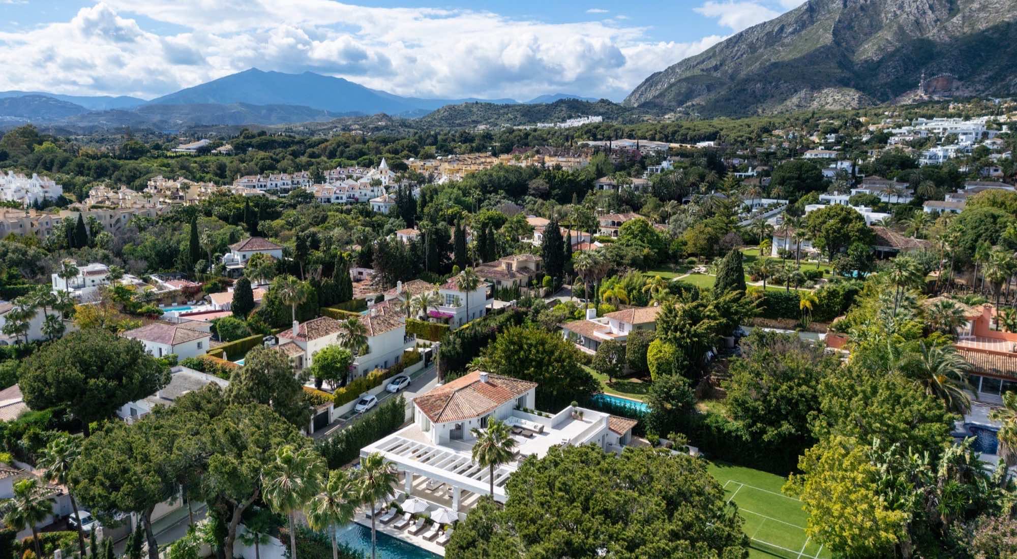 Villas for sale in Marbella seen from the air with La Concha behind