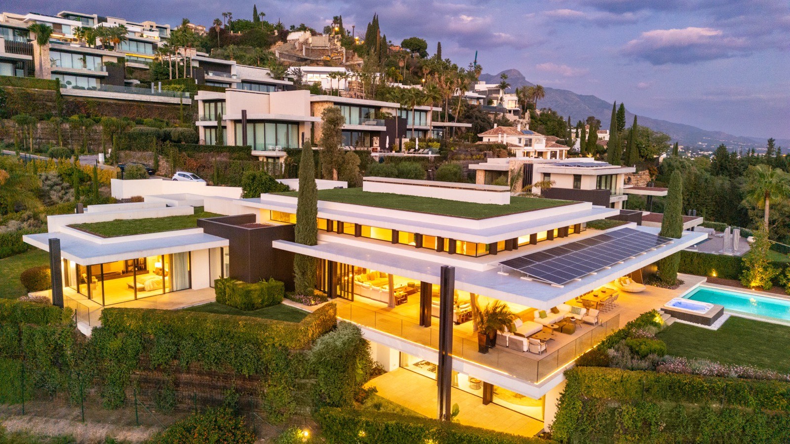 Contemporary hillside villas at dusk above Marbella