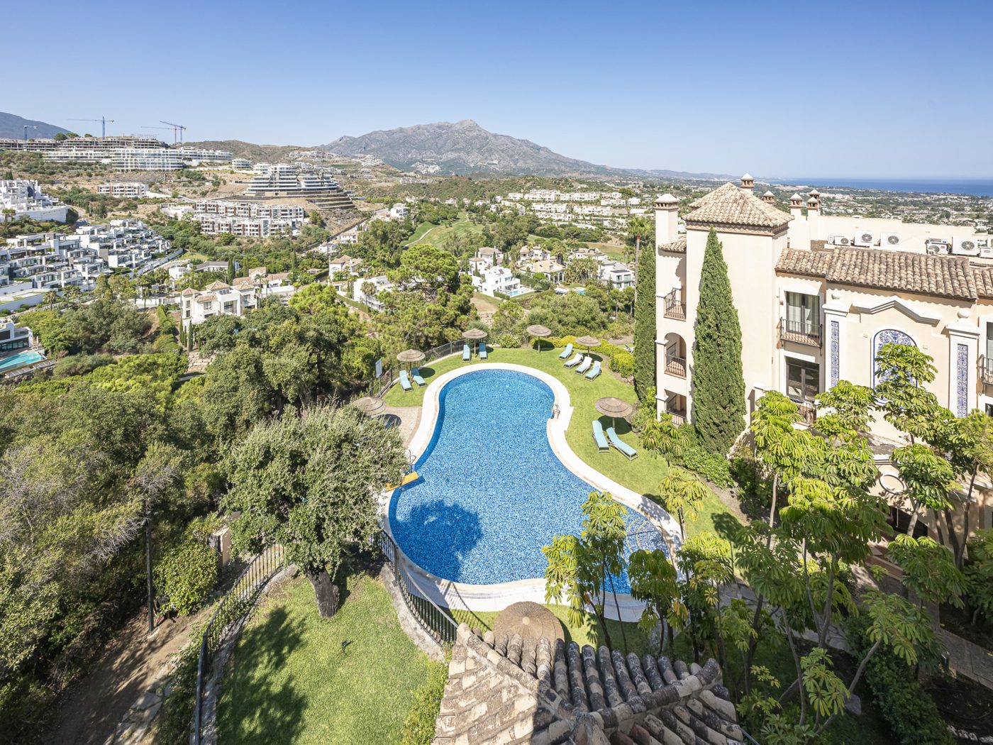 A pool among the villas of La Quinta with La Concha in the distance