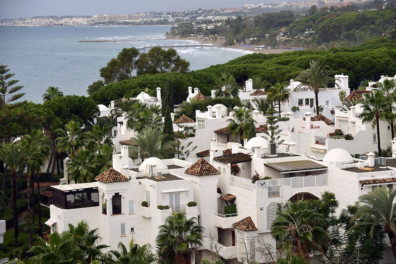 Whitewashed low rise apartments stepping down towards the sea in Marbella