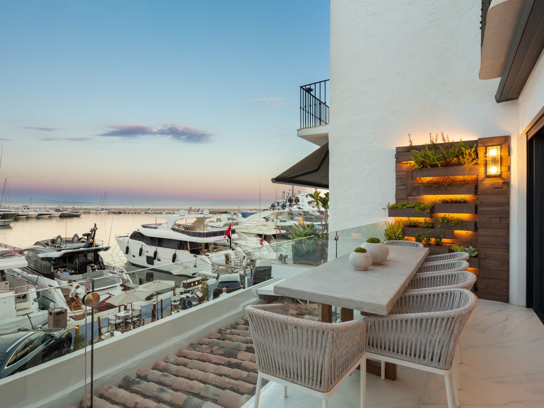 A terrace over the yachts at Puerto Banús at dusk
