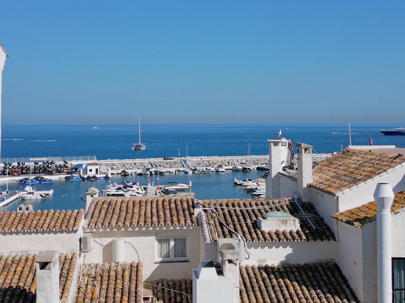 The whitewashed blocks of the port village at Puerto Banús with the marina beyond