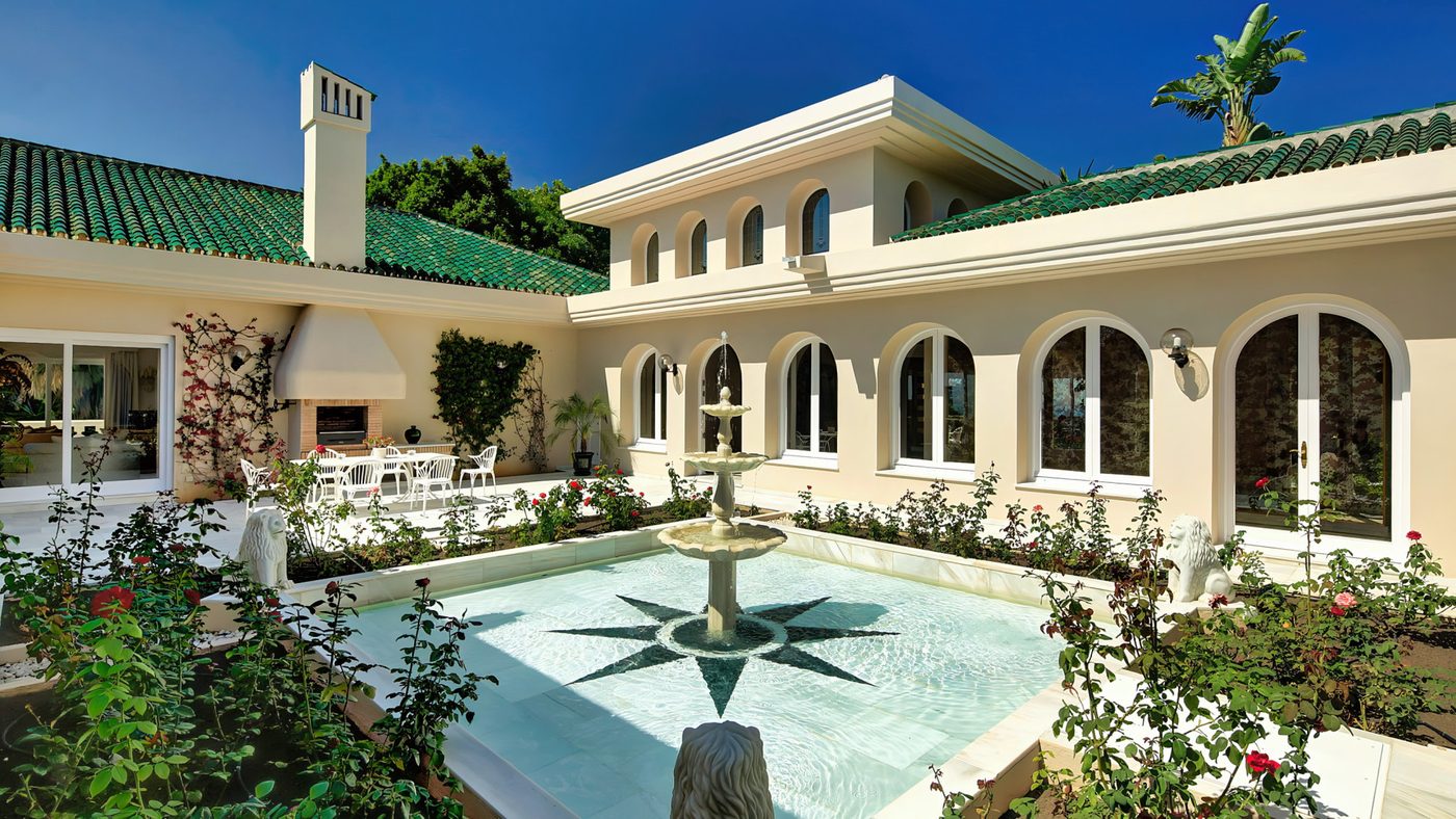 A house on the fairways at Río Real Golf, its courtyard fountain and green glazed roof