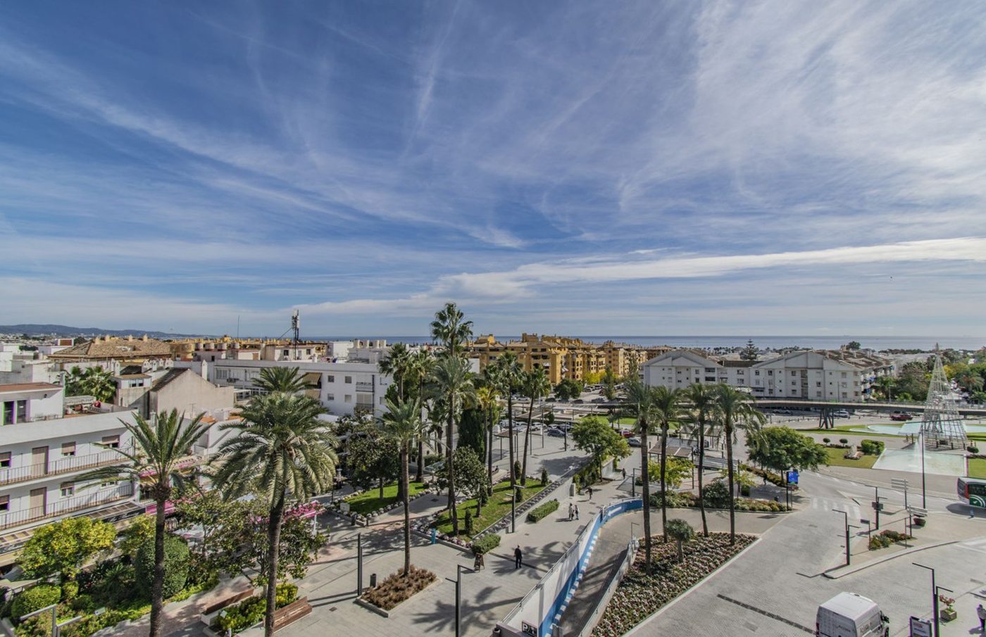 The bulevar of San Pedro de Alcántara from above, the palms and the town with the sea beyond