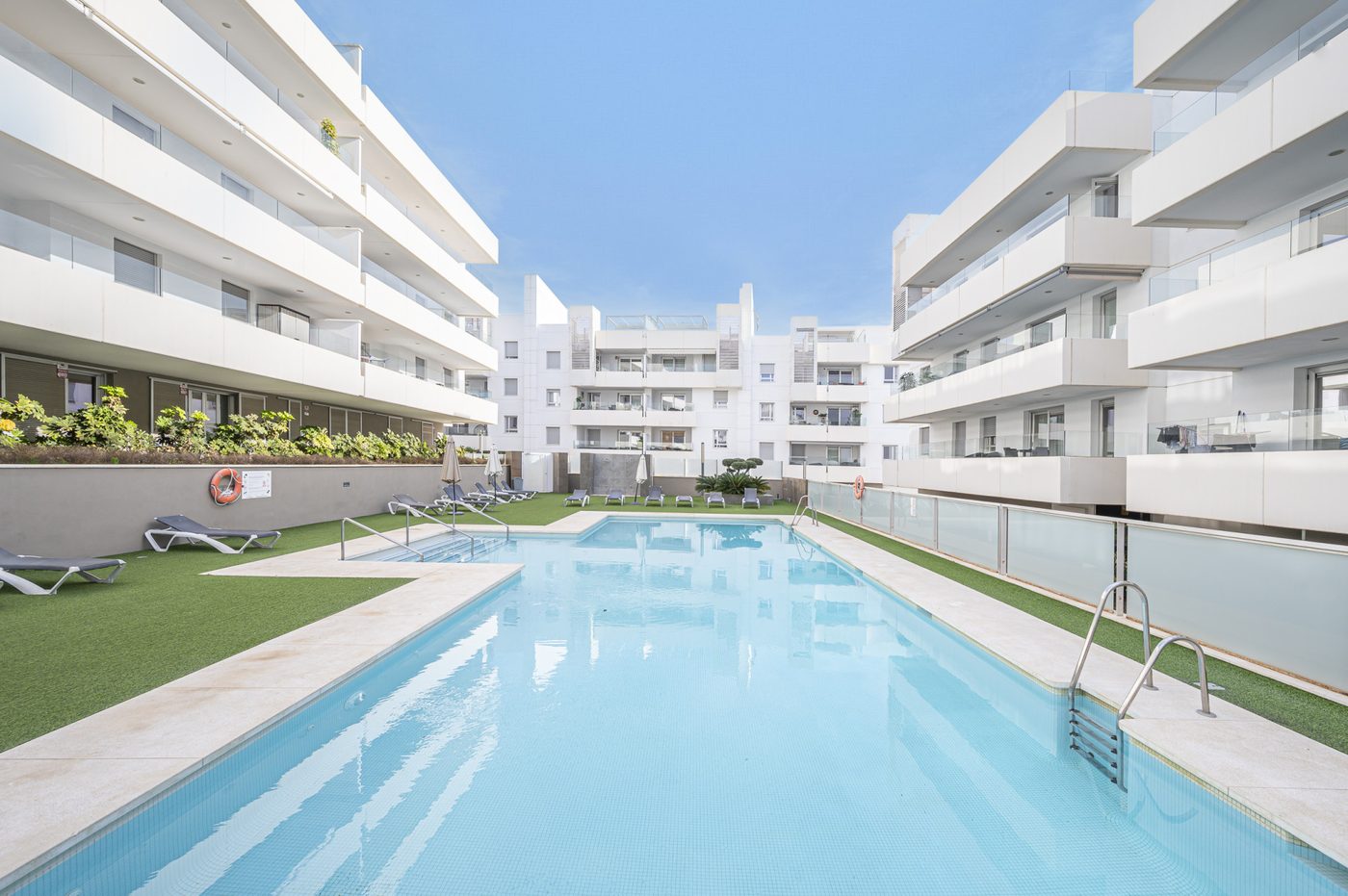 A shared pool between apartment blocks at Nueva Alcántara in San Pedro de Alcántara