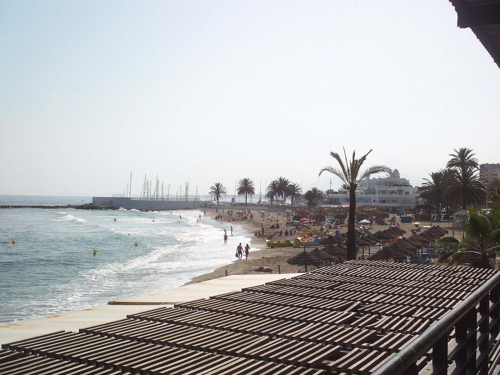 Marbella seafront promenade and beach lined with palm trees