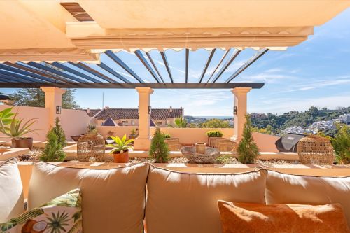 Elevated corner ground floor apartment in the gated Albatross Hill community, Nueva Andalucia, with a wraparound terrace, three en suite bedrooms and resort style shared facilities.